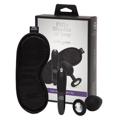 Fifty Shades of Grey We-Vibe Come to Bed Kit with black satin blindfold, compact vibrator, and silicone butt plug with crystal base.