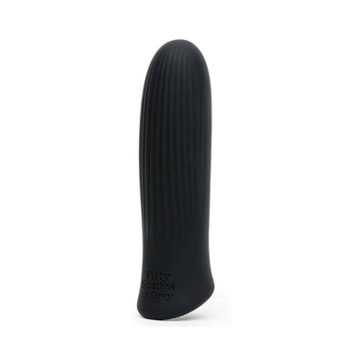 Black silicone bullet vibrator with subtle ridges and Fifty Shades of Grey logo on base, standing upright on white background.