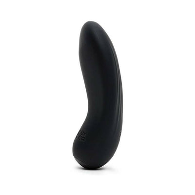 Sleek black pebble-shaped clitoral vibrator with ergonomic curve and smooth silicone finish standing upright on white background.