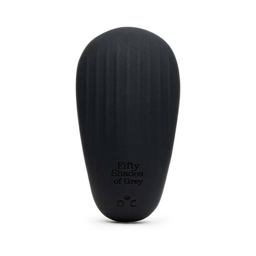 Black pebble-shaped Fifty Shades of Grey clitoral vibrator with subtle ridges and discreet control buttons.