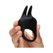 Hand holding a black silicone vibrating love ring with dual flexible ears for clitoral stimulation.