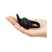 Black silicone Fifty Shades Sensation Rabbit Love Ring held in an open hand showing its compact size and flexible ears.