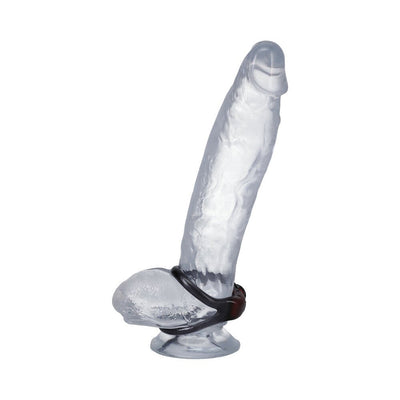 Clear silicone model of a penis wearing a black Firmtech Performing C-ring at the base.