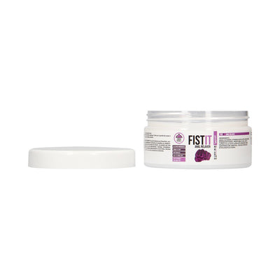 Open jar of Fist It Anal Relaxer gel with white lid beside it on a white background.