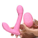 Hands holding a pink G-spot vibrator with flicking arm and matching remote control, made of smooth silicone.