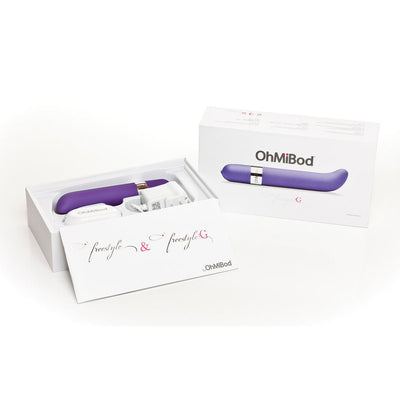 Freestyle G Spot Vibrator in purple with wireless transmitter, charger, and packaging box on white background.