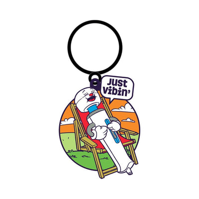 Enamel keychain featuring a cartoon wand vibrator relaxing in a chair with a speech bubble saying Just Vibin'