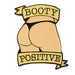 Vanilla light enamel pin featuring a stylized booty in black underwear with "Booty Positive" banner design.