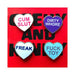 Set of four colorful heart-shaped enamel pins with bold playful phrases on a red background.