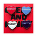 Set of four heart-shaped enamel pins labeled Dominant, Submissive, Submit, and Switch on a red background.