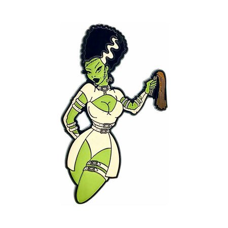 Enamel pin of a green-skinned character with black and white hair wearing a stylized bondage-inspired outfit holding a whip.