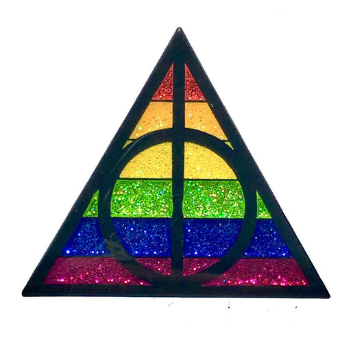 Triangle enamel pin with glitter rainbow stripes and black geometric design inspired by magical symbols.