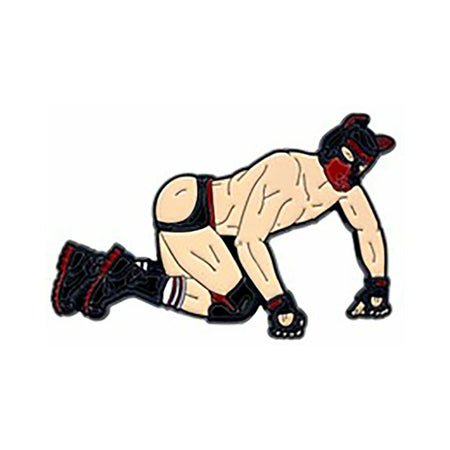 Enamel pin of a person in pup play gear with mask, gloves, boots, and minimal clothing in a crawling pose.