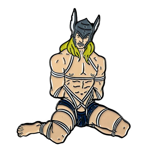 Enamel pin of a muscular character wearing a winged helmet and dark shorts, bound with white ropes in a seated pose.