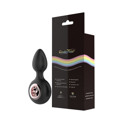 Black silicone anal plug with rose gold ring detail next to Gender Fluid branded packaging with rainbow design.
