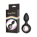 Black silicone Gender Fluid Tremor Ring Plug with rose metal ring, shown with its sleek black packaging featuring a rainbow stripe.