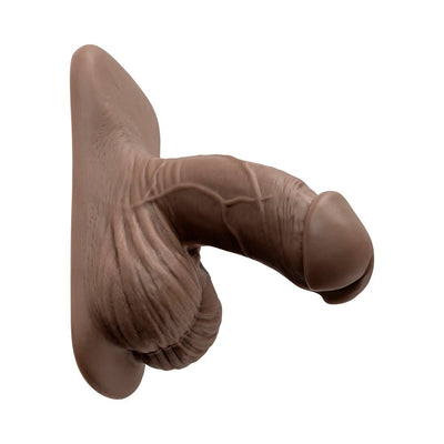 Realistic brown silicone packer with detailed texture and attached base for secure fit in underwear.