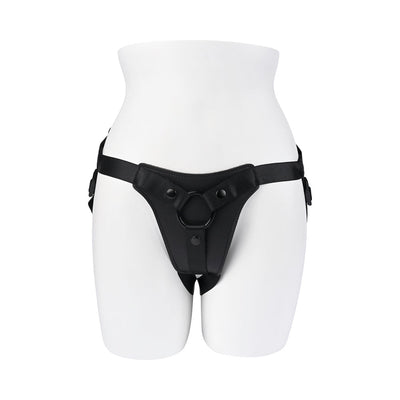 Black faux-leather adjustable strap-on harness with central ring displayed on white mannequin torso.