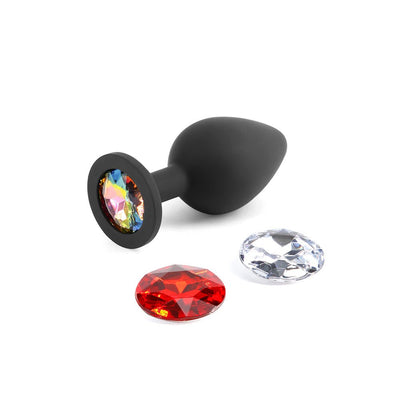Black silicone medium-sized plug with three interchangeable colorful gem attachments on a white background.