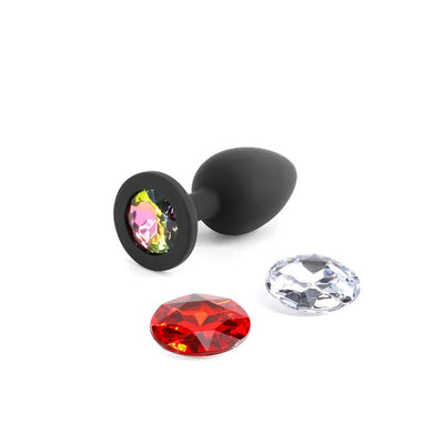 Black silicone small plug with three interchangeable colorful gem attachments in multicolor, red, and clear designs.
