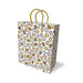 White gift bag with metallic gold, silver, rose gold, and bronze abstract shapes and gold woven handles.