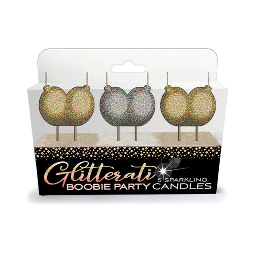 Set of five glittery gold and silver boobie-shaped party candles in clear packaging with black and gold label.