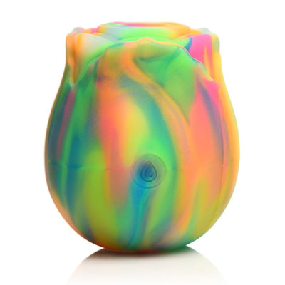 Rainbow-colored glow-in-the-dark rose-shaped clit stimulator with smooth silicone petals and a central suction area.