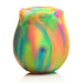 Rainbow-colored glow-in-the-dark rose-shaped clit stimulator with smooth silicone petals and a central suction area.