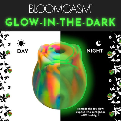 Glow-in-the-dark rose clit stimulator showing vibrant rainbow colors by day and glowing green at night.