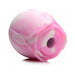 Compact rose-shaped clitoral vibrator in soft pink and white silicone with a central suction opening.