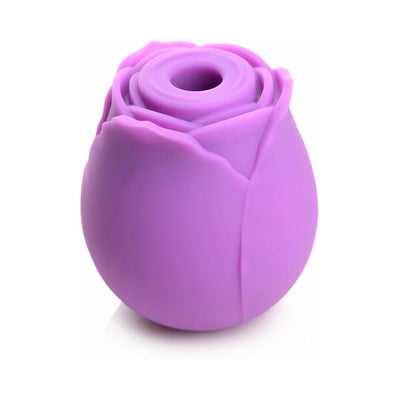 Purple silicone clitoral vibrator shaped like a rosebud with a central suction opening.