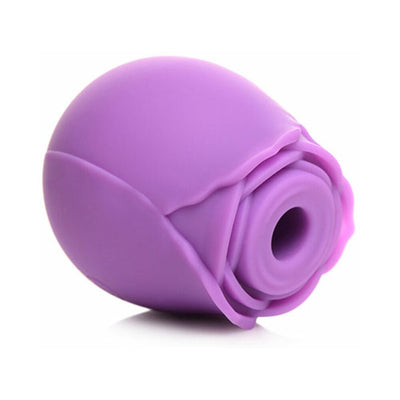 Purple silicone clitoral suction stimulator shaped like a blooming rose with a central suction opening.