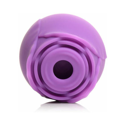 Purple silicone clitoral suction stimulator with a rose-inspired design and central suction opening.