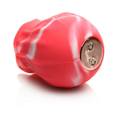 Compact red and white marbled silicone vibrator with metallic charging base on white background