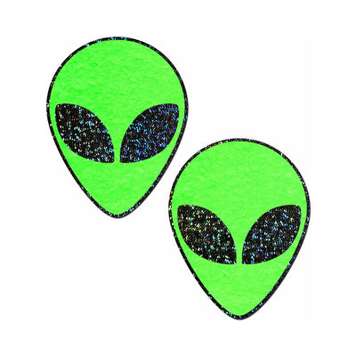 Pair of green glitter alien face-shaped pasties with black glitter eyes on a white background.