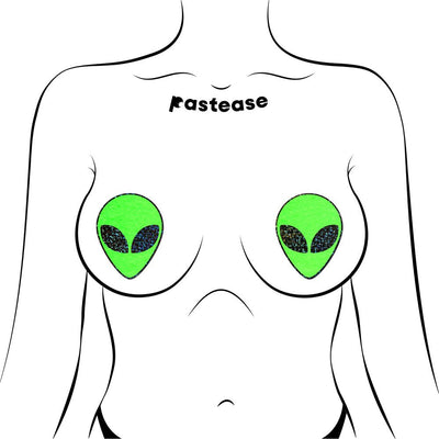 Illustration of green glitter alien face pasties applied on a stylized female chest outline.