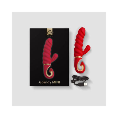 Red Gvibe Gcandy MINI dual-stimulation vibrator with spiral texture, gold accent, USB charging cable, and black packaging box.