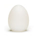 Frosted white egg-shaped reusable pleasure sleeve with smooth, semi-translucent texture.