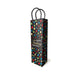 Tall black birthday gift bag with colorful polka dots and gold script text, featuring sturdy black woven handles.