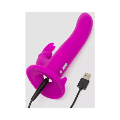 Purple silicone vibrating strap-on insert with USB charging cable attached, designed for use with adjustable harness.