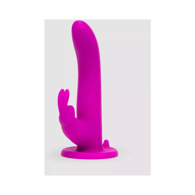 Purple silicone vibrating strap-on insert with curved shaft and external stimulator on a flat base.