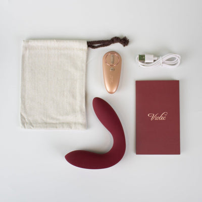 Hercules Remote C-shape Vibrating Plug in wine red with remote control, USB charger, storage pouch, and instruction manual on white background.