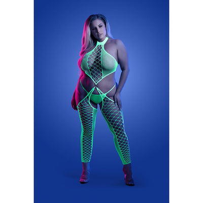 Plus size model wearing neon green high neck fishnet bodystocking with matching G-string under blue lighting