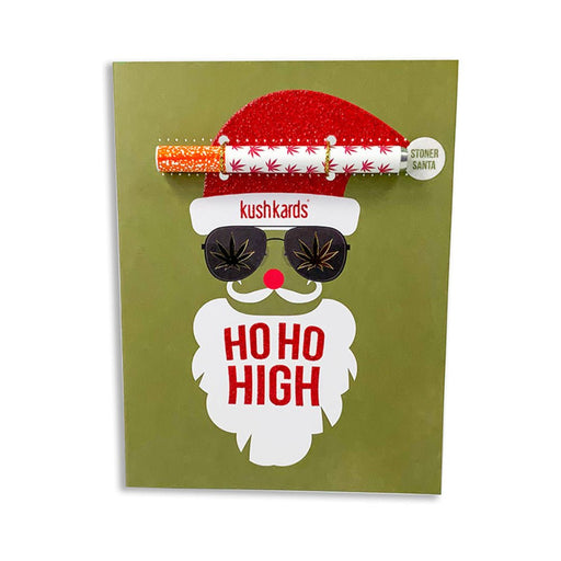 Holiday greeting card with a Santa face wearing sunglasses and a red glitter hat, featuring a one hitter pipe attached.