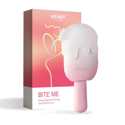 Honey Play Box Bite Me cream pop-shaped stimulator with soft silicone cover and pink handle next to its pink gradient packaging box.