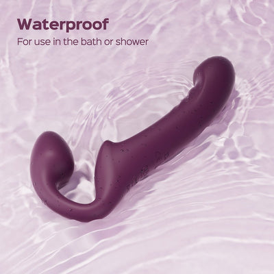 Purple Honey Play Box Bliss rotating head strapless strap-on shown in water, highlighting its waterproof feature for bath or shower use.