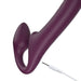 Deep purple strapless strap-on with curved rotating head and bulbous wearable shaft, shown with white USB charging cable.