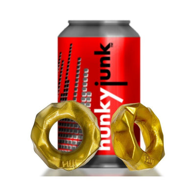 Two gold textured Hunkyjunk Fractal Tactile Cockrings displayed in front of a red Hunkyjunk branded can.