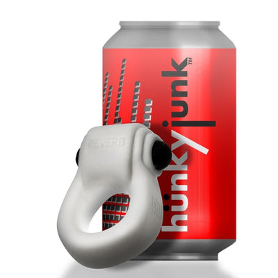 White rubbery cockring with black bullet vibrator displayed in front of a red hünkyjunk branded can.