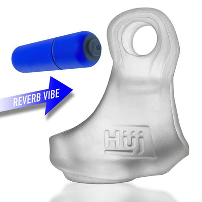 Clear silicone cock and ball sling with embossed logo and detachable blue bullet vibrator shown separately with directional arrow.